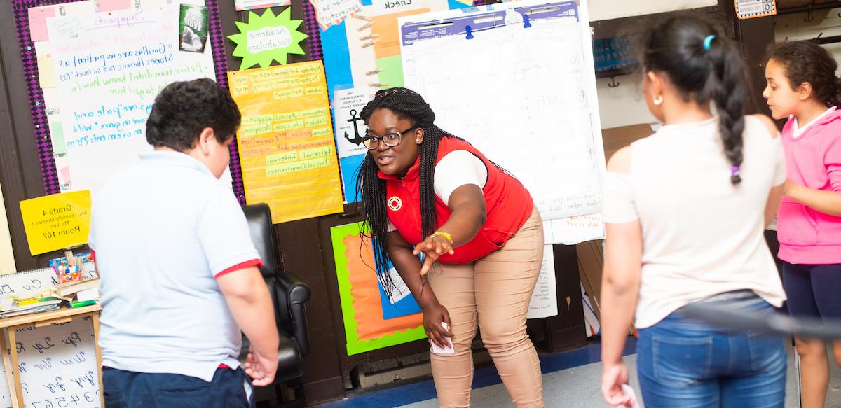 City Year volunteer working with children